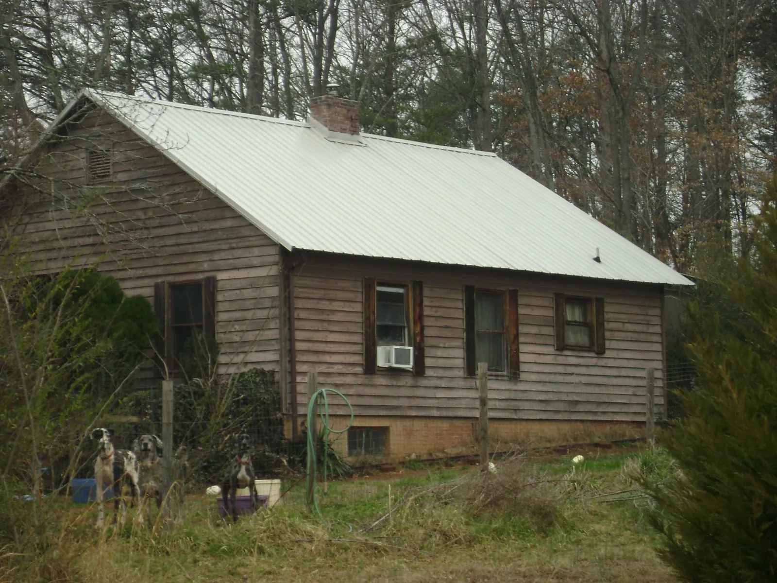 White metal roof on an old wood sided farmhouse, from a Metal Roof Installation job in Hamshire